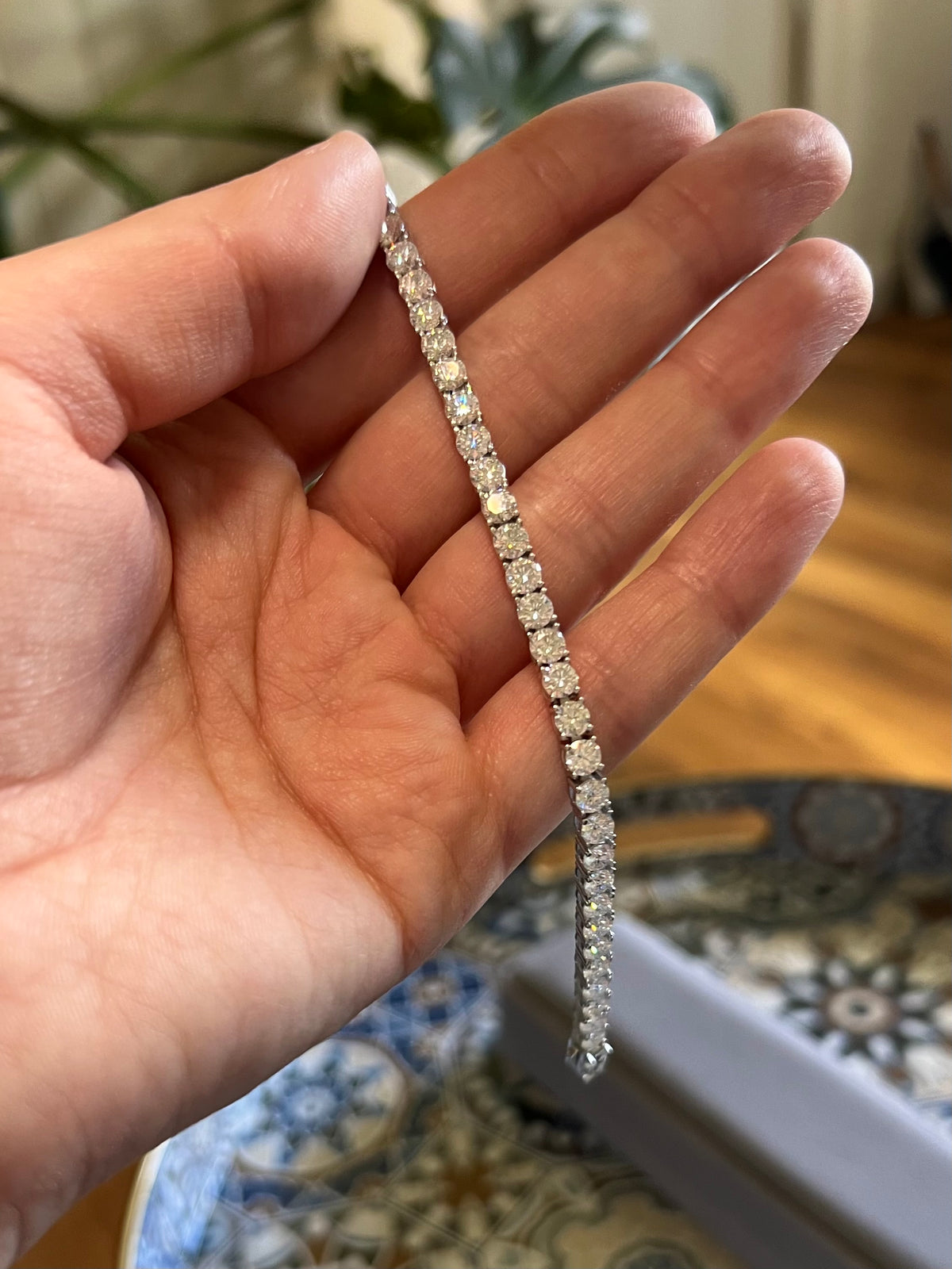 Moissanite tennis bracelet held in the hand