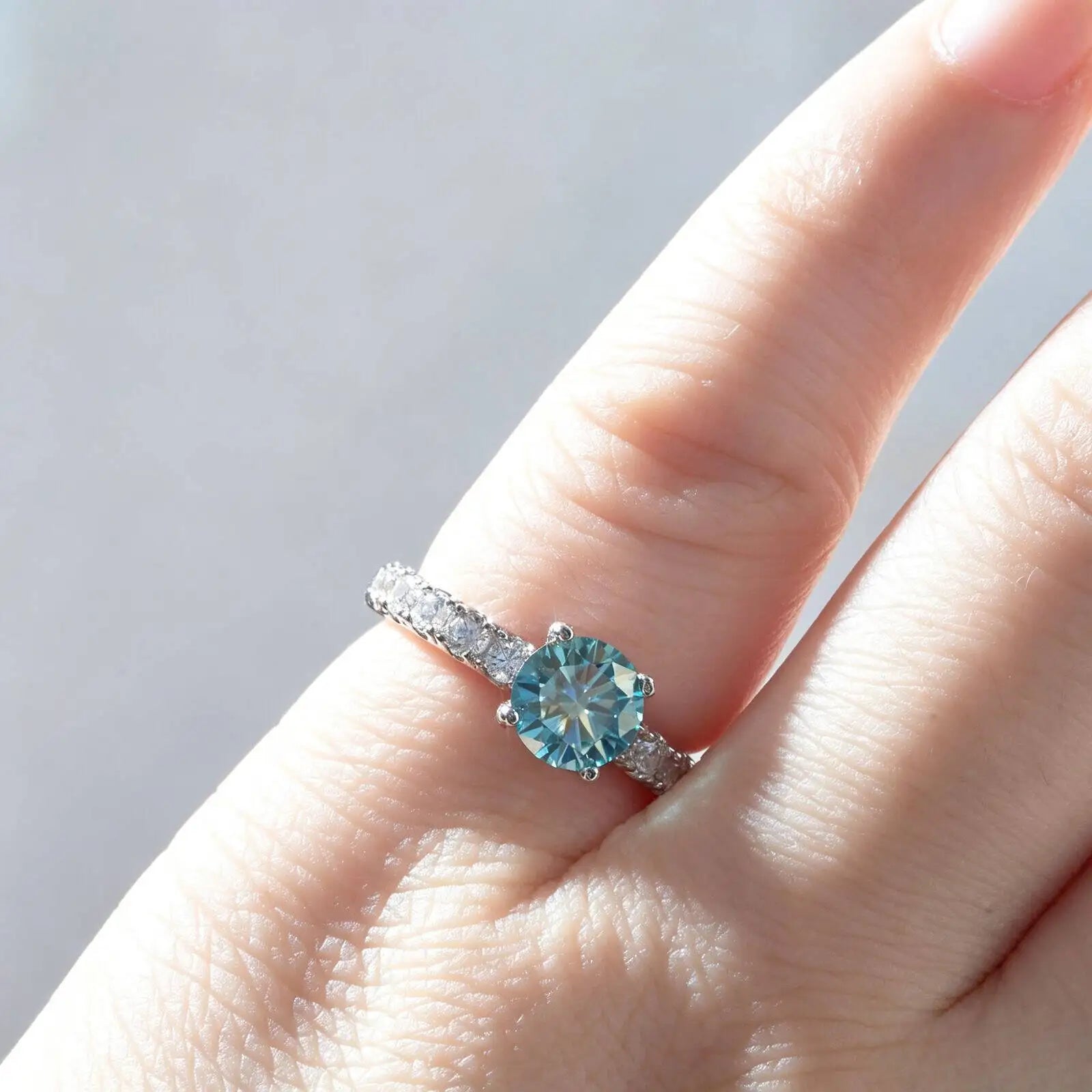 Moissanite pavé solitaire ring on the finger