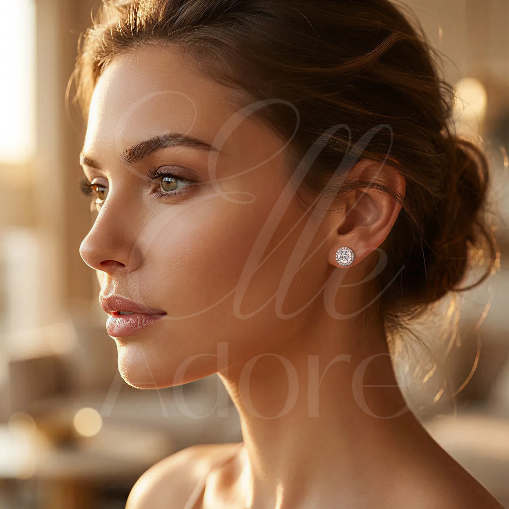 Close-up of a woman wearing a diamond earring with 'Elle Adore' branding.