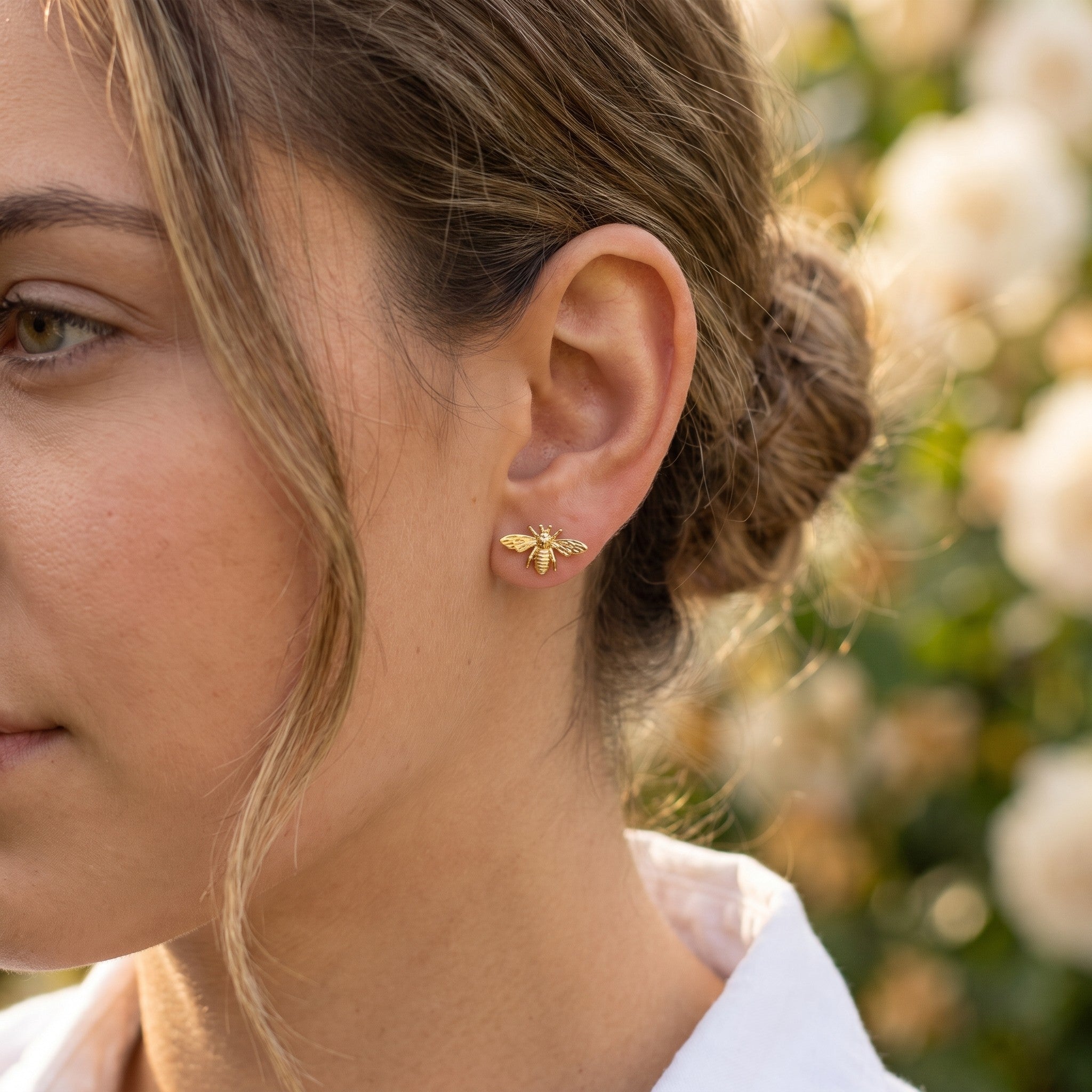 Gold vermeil Save The Bees stud earring worn on the ear