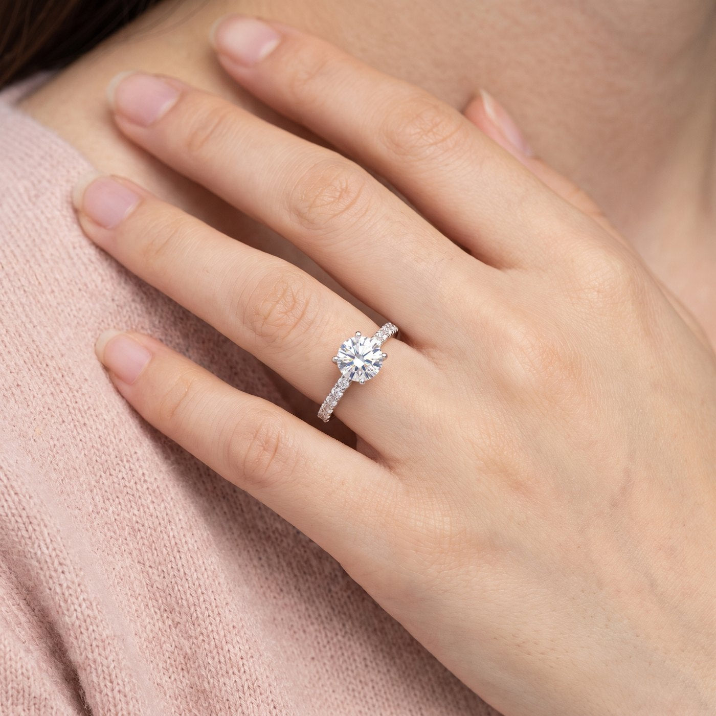 Pavé moissanite solitaire ring on a woman's hand
