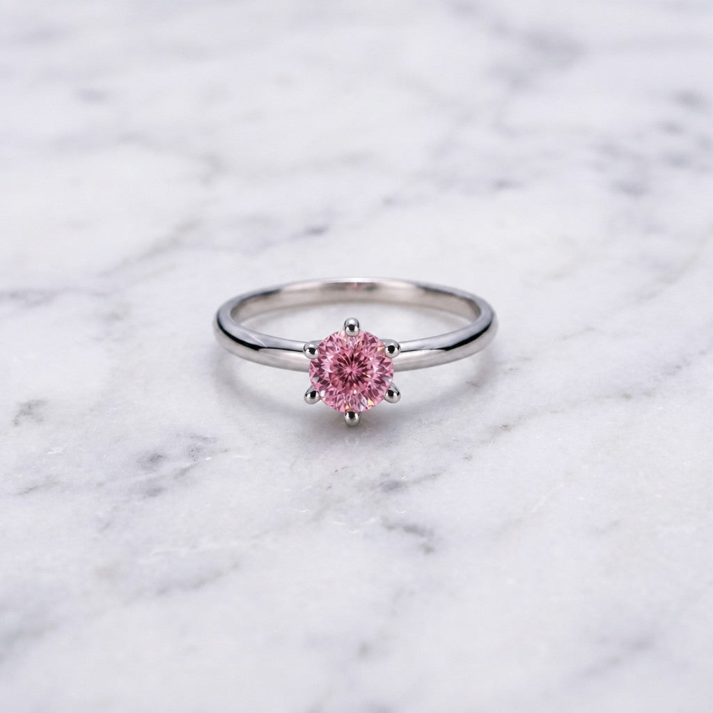 Sakura Pink Moissanite solitaire ring on white marble